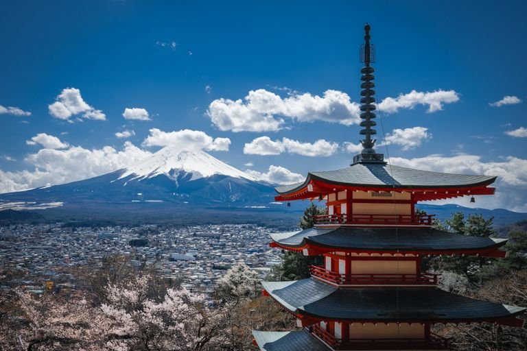 Stunning view of Chureito Pagoda and Mount Fuji with cherry blossoms in spring, Japan.